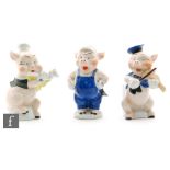Three 1930s Walt Disney toothbrush holders modelled as the Three Little Pigs from the 1933 film,