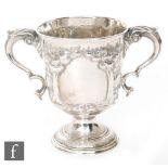 A hallmarked Irish silver twin handled pedestal cup later decorated with two soldiers with rifles