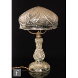 A 20th Century Stourbridge cut crystal lamp with a mushroom shade on a baluster column with domed