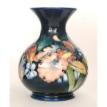 A Moorcroft vase of bulbous form with a flared collar neck decorated in the Frilled Orchid pattern,