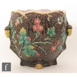 A 19th Century majolica jardiniere relief decorated with flowers and foliage against a textured