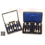 A cased set of six hallmarked silver teaspoons and a pair of tongs decorated with a feather edge,