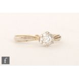A 18ct diamond cluster ring, seven brilliant cut stone to knife edged shoulders, ring size N.