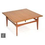 Unknown, probably Danish - A teak coffee table of square form, raised to a stretcher frame,