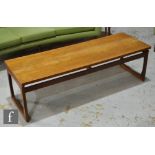 G-Plan Furniture - A teak coffee table of rectangular form raised to strut loop supports,