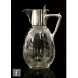 Christofle - A late 19th Century continental clear crystal glass claret jug of footed ovoid form,