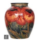 William Moorcroft - A vase of swollen form with a roll rim neck decorated in the Big Poppy pattern