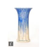 Ruskin Pottery - An early 20th Century lily vase of footed trumpet form decorated in a tonal blue