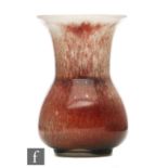 Ruskin Pottery - A small high fired vase of globe and flared shaft form decorated in a sang de