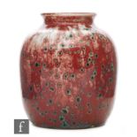 Ruskin Pottery - A small high fired vase of barrel form with a roll rim neck,