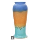 Ruskin Pottery - A crystalline glaze vase of tapered footed form decorated in a blue to orange to