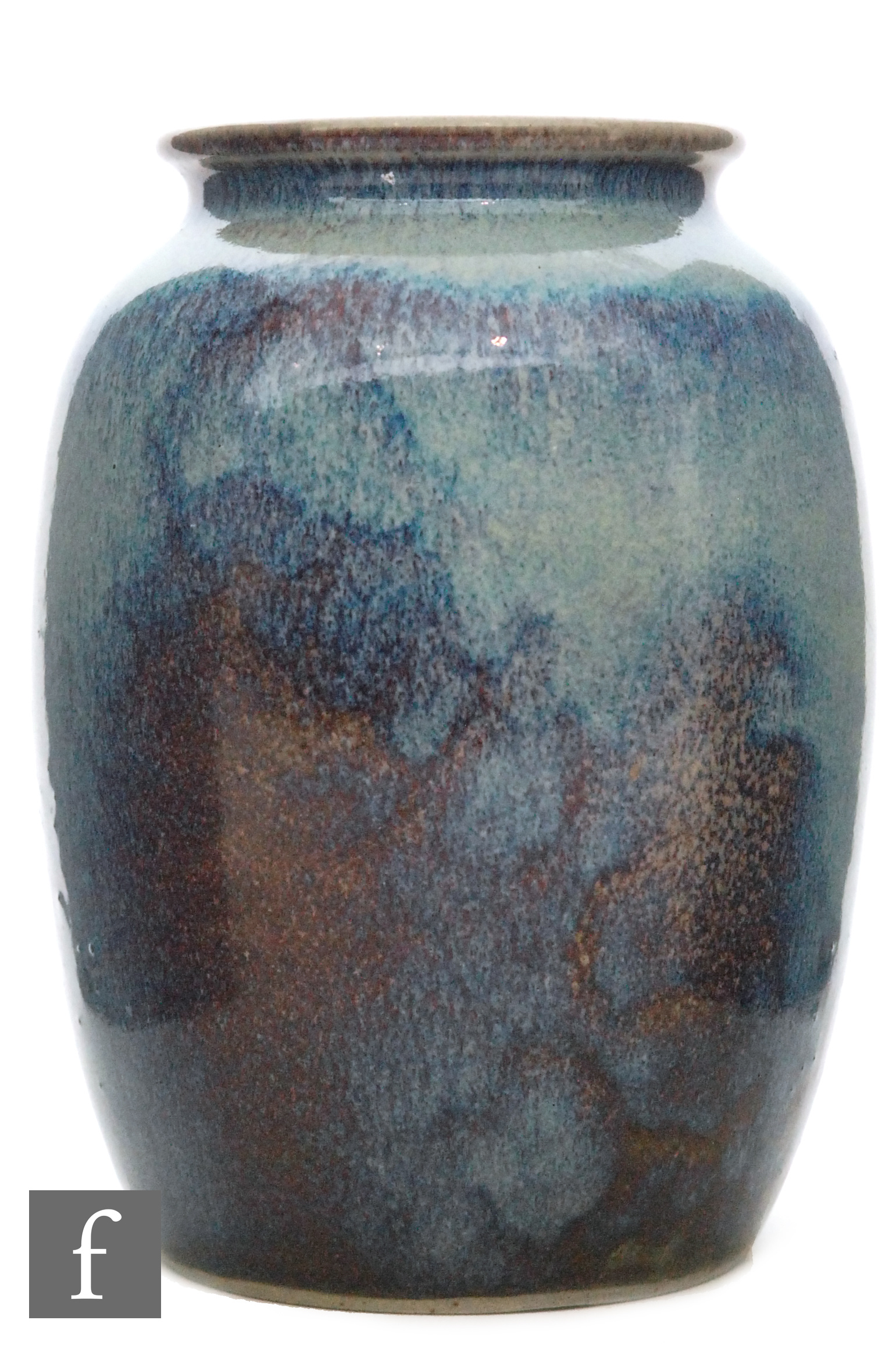 Ruskin Pottery - A high fired vase of barrel form with a roll rim neck decorated in a mottled green