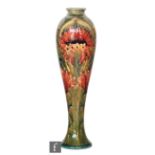 William Moorcroft - A vase of slender tapering form decorated in the Revived Cornflower pattern,