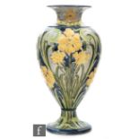 William Moorcroft - James Macintyre & Co - A Florian Ware vase of footed baluster form decorated