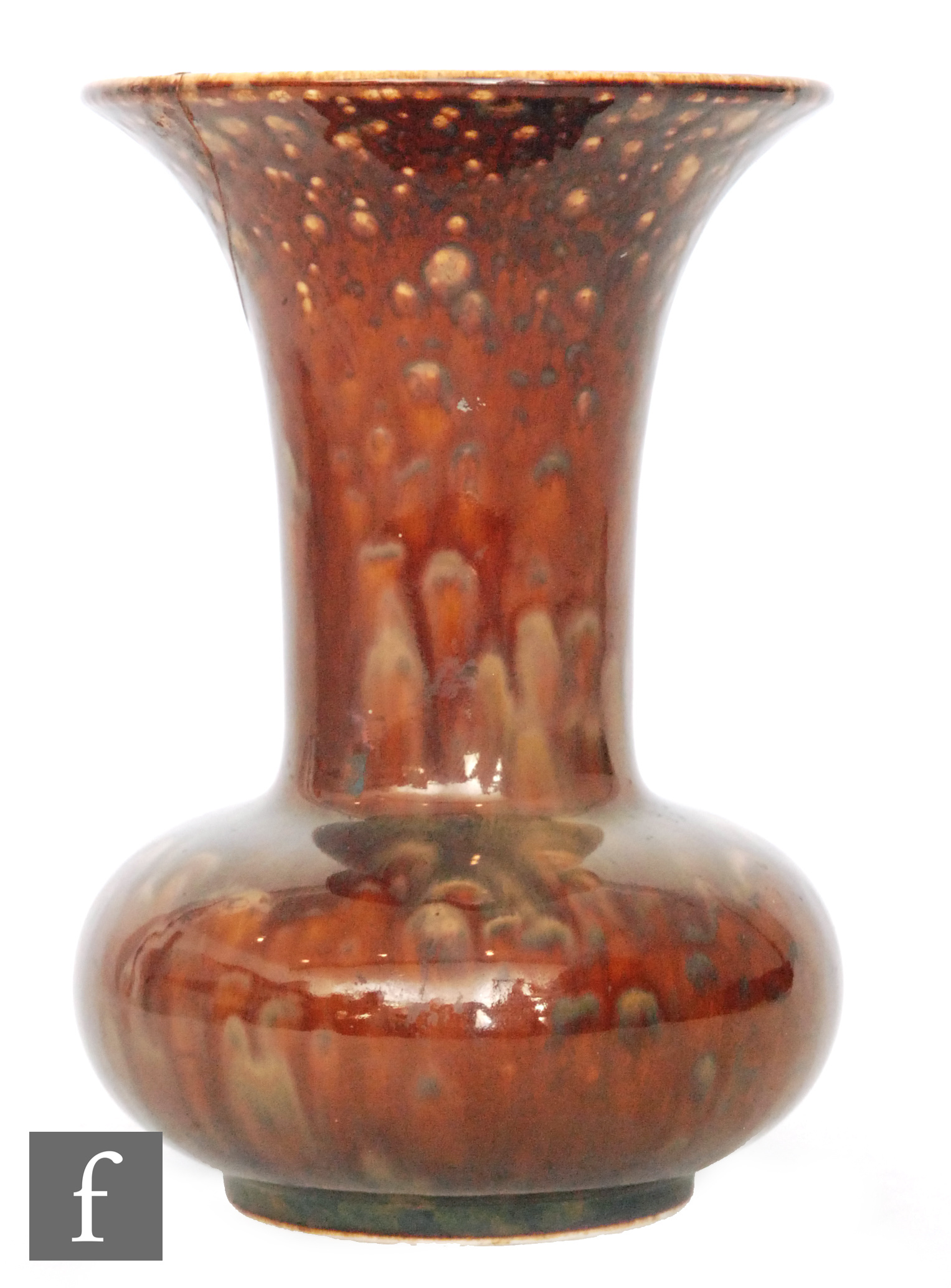 Ruskin Pottery - A souffle glaze vase of compressed form with a flared neck decorated in a mottled