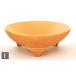 Ruskin Pottery - A crystalline glaze tri-footed bowl decorated in an all over mottled orange raised