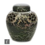 Ruskin Pottery - A small high fired pot pourri and domed cover decorated in a dark green speckled
