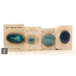 Ruskin Pottery - Four assorted roundels mounted as brooches of varying form,