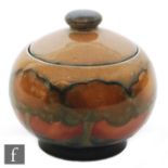 William Moorcroft - A small ovoid jam pot and cover decorated in the Eventide pattern with a