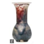 Ruskin Pottery - A small high fired vase of globe and flared shaft form decorated with lavender and