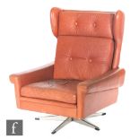 Attributed to Svend Skipper, Danish - A tan leather upholstered swivel armchair,