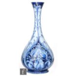 William Moorcroft - James Macintyre & Co - A Florian Ware bottle vase decorated with tubelined blue