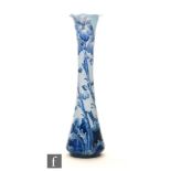 William Moorcroft - James Macintyre & Co - A Florian Ware vase of slender form with waved rim edge