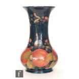 William Moorcroft - A Pomegranate pattern vase of globe and flared shaft form,