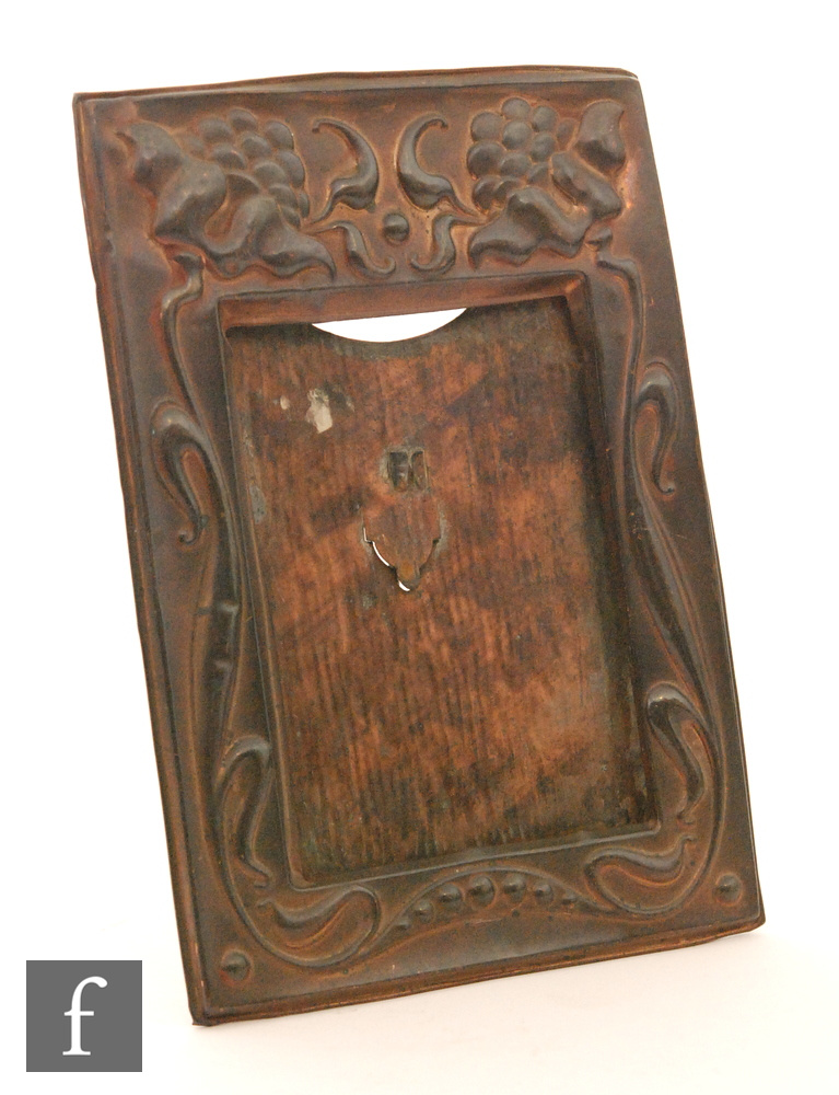 Unknown - A copper rectangular easel photograph frame decorated with embossed stylised flower heads