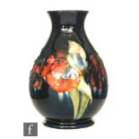 William Moorcroft - A vase of swollen form with a squat flared neck decorated in the Flambe Frilled