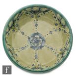 William Moorcroft - A footed bowl decorated with a Florian type tubelined foliate pattern with a