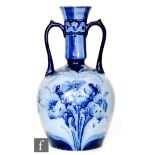 William Moorcroft - James Macintyre & Co - A Florian Ware blue on blue twin handled vase decorated