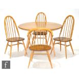 Ercol - A model 384 blonde elm and beech drop leaf dining table,