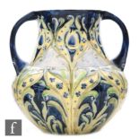 William Moorcroft - James Macintyre & Co - A twin handled Florian Ware vase decorated with