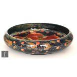 William Moorcroft - A large footed 'float' bowl decorated in the Pomegranate pattern with a band of