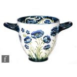 William Moorcroft - James Macintyre & Co - A small twin handled footed cache pot decorated in the