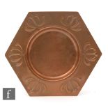 An early 20th Century WMF Art Nouveau hexagonal copper dish with border decorated in relief and