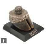 A 19th Century inkwell in the form of a horses hoof with Eastern white metal mount on an ebonised