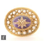 A modern hallmarked oval brooch with diamond encrusted star set of a cabochon amethyst all within a