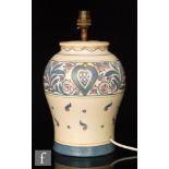 A Bursley Ware table lamp base designed by Charlotte Rhead decorated with scrolls,