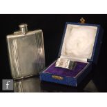 A hallmarked silver rectangular hip flask with engine turned decoration to whole below bayonet cap,