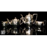 A hallmarked silver four piece tea set of boat shaped panel form with diamond detail to borders and