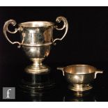 A hallmarked silver twin handled trophy of plain form, engraved with initials, weight 19.