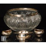 A hallmarked silver and clear cut glass fruit bowl with a silver Art Deco tea strainer and a pair