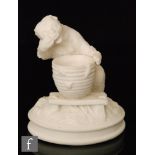 A 19th Century Parian vesta holder modelled as a bear stealing honey from an overturned beehive,