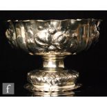 An early 20th Century continental silver pedestal bowl with embossed folaite and fruit decoration