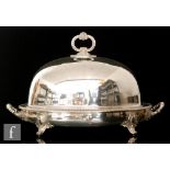 A 20th Century plated oval meat cover and two handled warmer, beaded edge decoration on scroll feet,