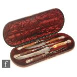 A cased Victorian antler handled five piece carving set with silver ferrules and terminals,