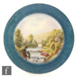 A Royal Worcester blue ground plate with central painted river landscape scene signed Flaxman,