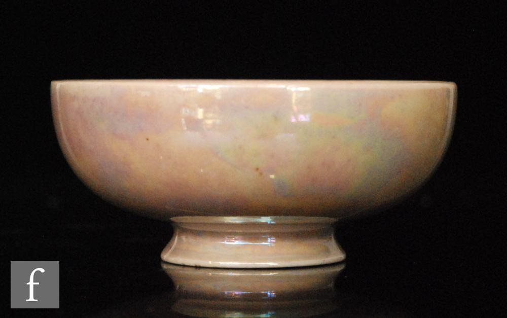 A miniature Ruskin Pottery footed bowl decorated in an all over pale pink lustre, impressed marks,